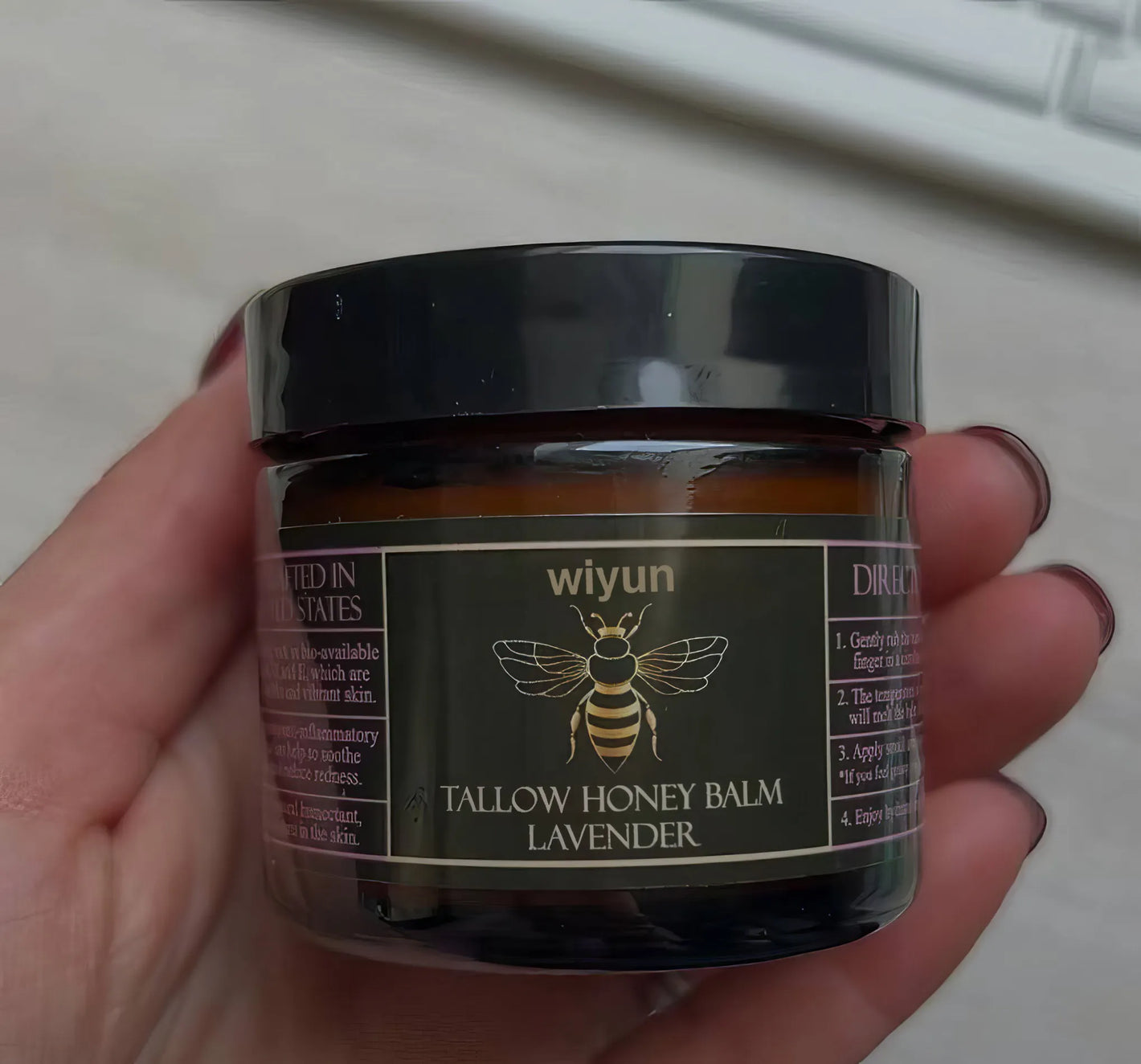 Velivor Tallow Honey Balm Lavender jar held in hund mit black und gold label